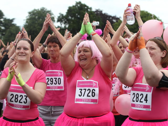 2011 - Over four thousand women warm up before the start in the 5k Race for Life at Abington Park in Northampton.