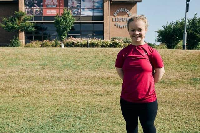 Maisie Summers-Newton standing outside of Moulton Leisure Centre
