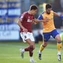 Shaun McWilliams keeps a close eye on Mansfield's Stephen McLaughlin during the Cobblers play-off semi-final first leg at Mansfield