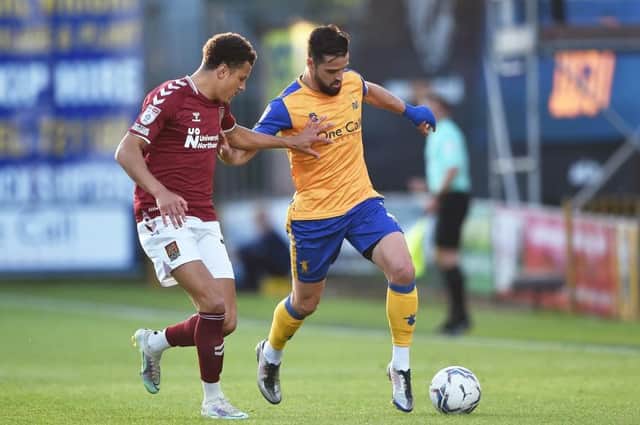 Shaun McWilliams keeps a close eye on Mansfield's Stephen McLaughlin during the Cobblers play-off semi-final first leg at Mansfield