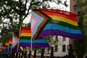 The much more inclusive New Pride Flag which integrates the Trans Pride Flag along with a black and brown stripe for People of Colour. (Photo by ANGELA WEISS/AFP via Getty Images)