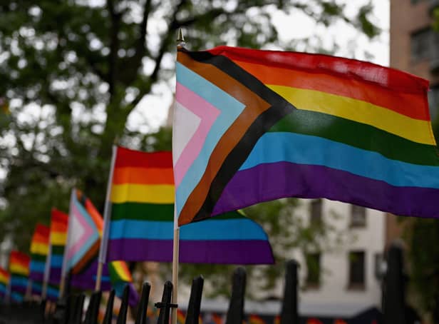 The much more inclusive New Pride Flag which integrates the Trans Pride Flag along with a black and brown stripe for People of Colour. (Photo by ANGELA WEISS/AFP via Getty Images)