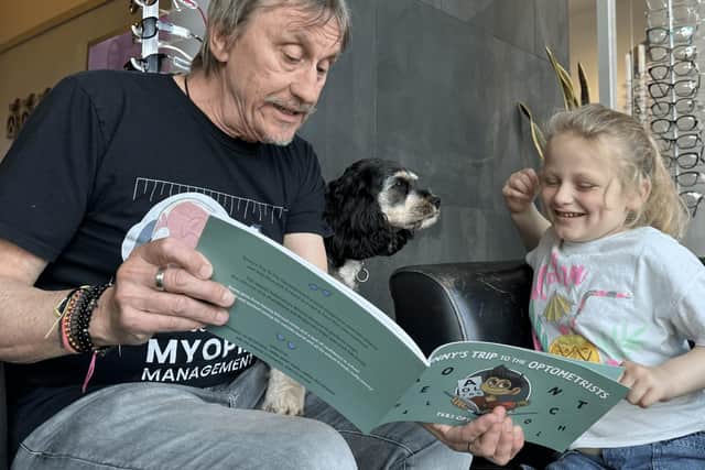 Brian Tompkins reading the TK&S children's book to a young patient