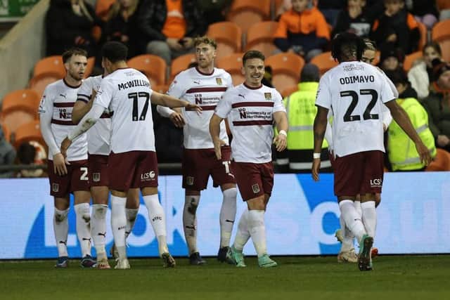 Sam Hoskins is all smiles as the Cobblers players celebrate his winning goal at Blackpool on Tuesday (Picture: Pete Norton/Getty Images)