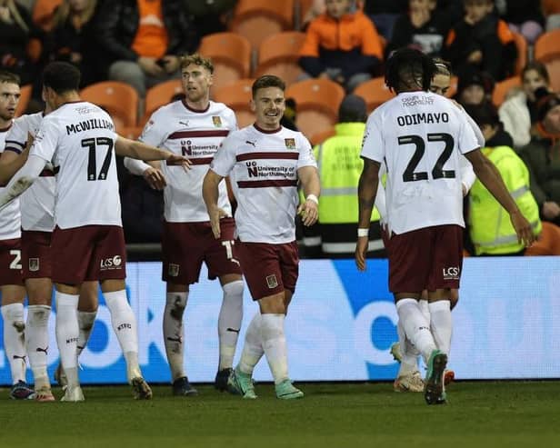 Sam Hoskins is all smiles as the Cobblers players celebrate his winning goal at Blackpool on Tuesday (Picture: Pete Norton/Getty Images)