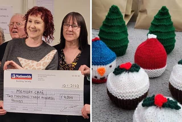 Angie Rose (left) and Debbie Brumby with their charity cheque for the Memory Cafe and some of their festive woollen wares.