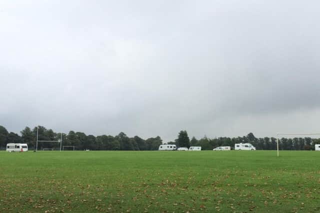 Eight caravans are parked on Northampton Racecourse.