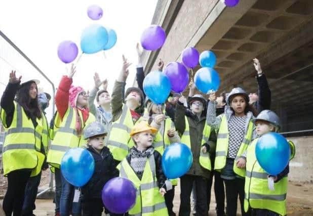 Children mark the topping out ceremony at NIA in December 2015