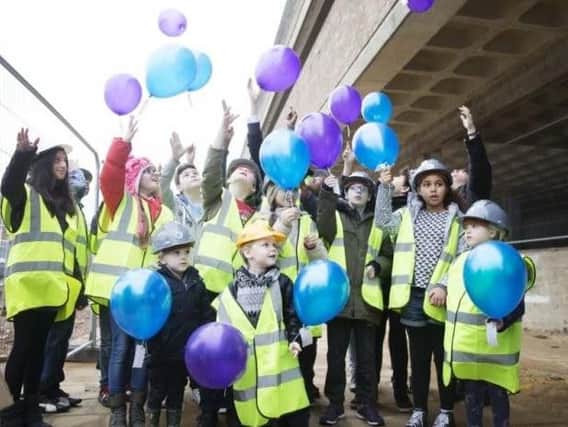 Children mark the topping out ceremony at NIA in December 2015