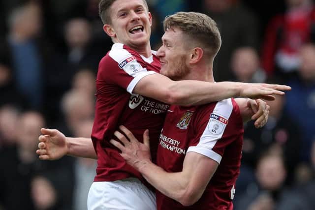 Aaron Phillips and Michael Smith celebrate the Cobblers' opening goal in the 2-1 win over Charlton