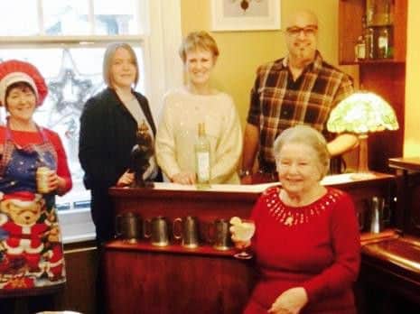 Enjoying a drink in the care home's in-house pub, the Resident's Arms.