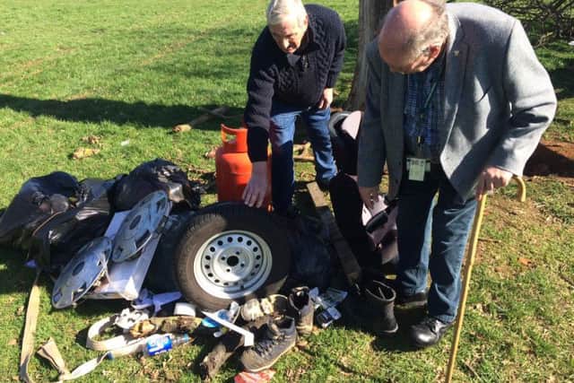 Councillor Graham Walker and Councillor Phil Larrett survey some of the rubbish left in the 24 hours period, which includes tyres, gas canisters, boots and nappies.