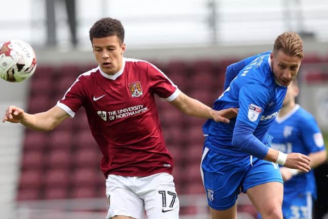 Shaun McWilliams tussles with Gillingham's Lee Martin