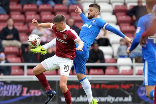 Aelx Revell battles with Gillingham's Max Ehmer