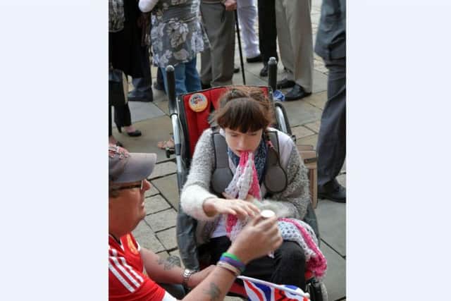 A little girl lights a candle at the vigil.