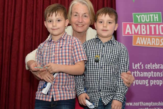 David & James Monk, Standens Barn Primary School winners of the Community Award, receive their award from the leader of Northamptonshire County Counci, Councillor Heather Smith