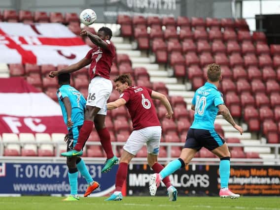 Aaron Pierre goes up for a header