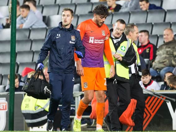 Matt Crooks trudges off the Stadium MK pitch after he suffered his knee injury on Tuesday night (Picture: Kirsty Edmonds)