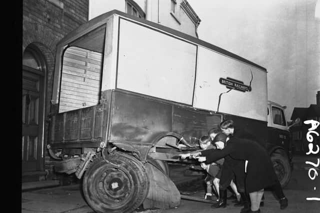 Children inspect a crashed lorry in St James Square, Northampton on January 1, 1959