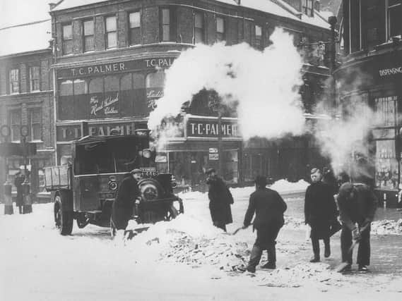 Clearing away the snow from Northampton's Drapery at its junction with Gold Street are four workmen with shovels. The lorry in the middle of the road is steam-powered which must have provided a welcome warming presence during the harsh winter of 1947 which began on January 21st. Several cold snaps brought wide-spread chaos with coal shortages at power stations resulting in  domestic electricity supplies restricted to a chilly nineteen hours a day. Crops rotted in fields adding extra hardship on top of rationing, still in place after the Second World War. 
The thaw in Mid-March caused widespread flooding throughout the UK.