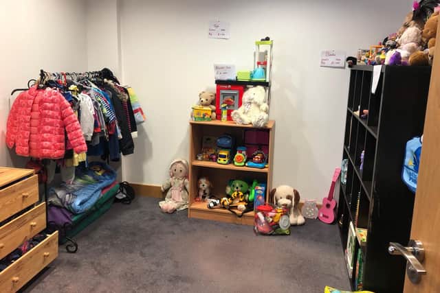 The charity shop has a room for children's clothes, toys and footwear.
