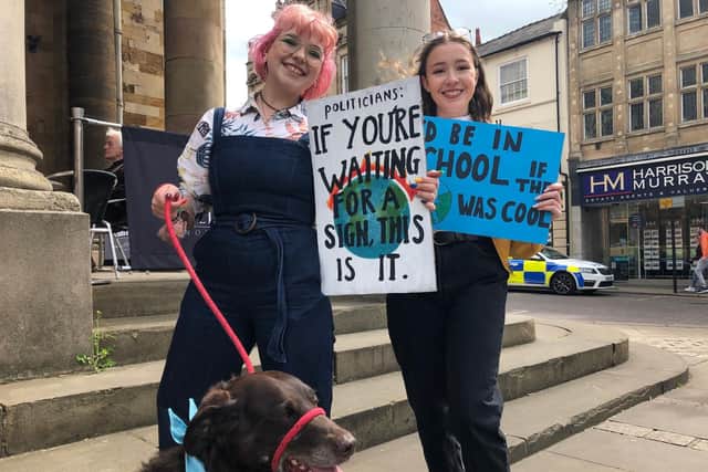 Pictured left-right: 17-year-old NSG pupils and activists, Jasmin Geari and Isabelle Hannon-Thompson, with chocolate Labrador, Idgi.