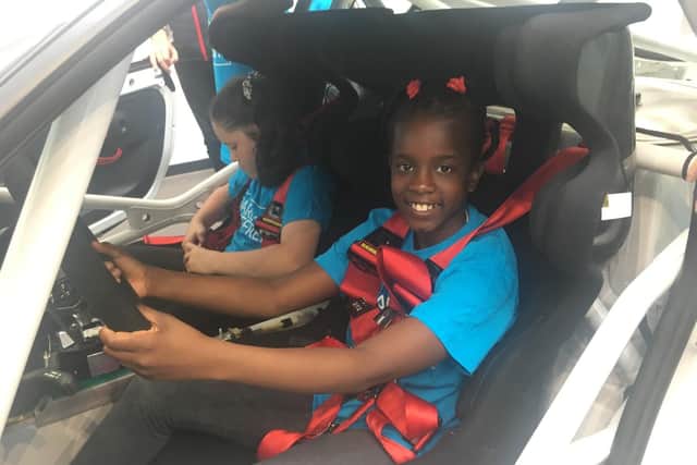 One of the Hunsbury Park Primary School pupils in a Porsche at the Dare To Be Different Event at Silverstone