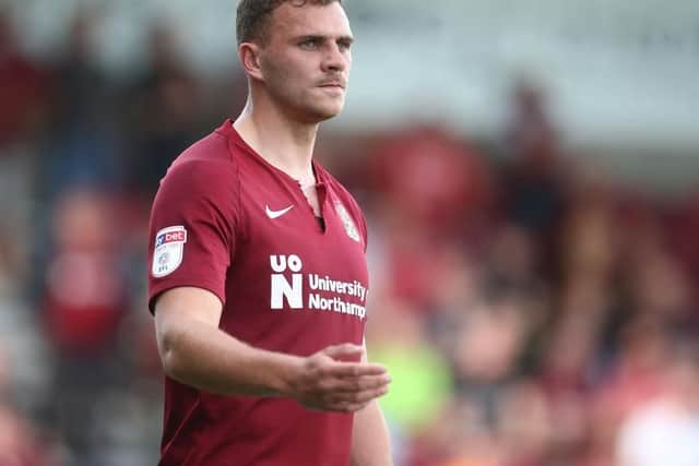 Another game, another ripped shirt for Cobblers striker Harry Smith
