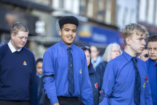 The parade through the town centre drew applause from hundreds of onlookers.