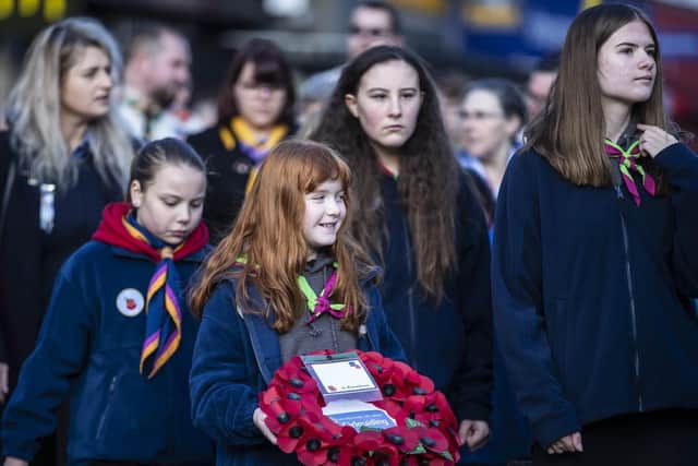 A Northamptonshire guide carries her troop's wreath for the memorial.