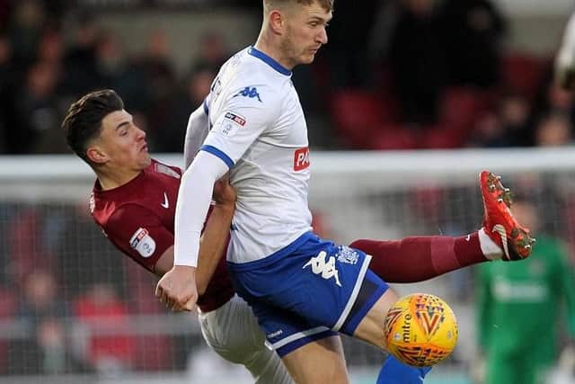 Cobblers midfielder Regan Poole tussles with Bury's former Town striker Michael Smith at Sixfields (Pictures: Sharon Lucey)