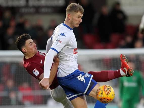 Cobblers midfielder Regan Poole tussles with Bury's former Town striker Michael Smith at Sixfields (Pictures: Sharon Lucey)