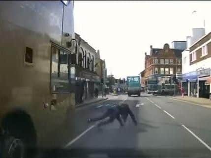 A pedestrian had a lucky escape after falling into the road in front of a bus and car. Video: Matthew Fishlock