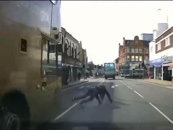 A pedestrian had a lucky escape after falling into the road in front of a bus and car. Video: Matthew Fishlock