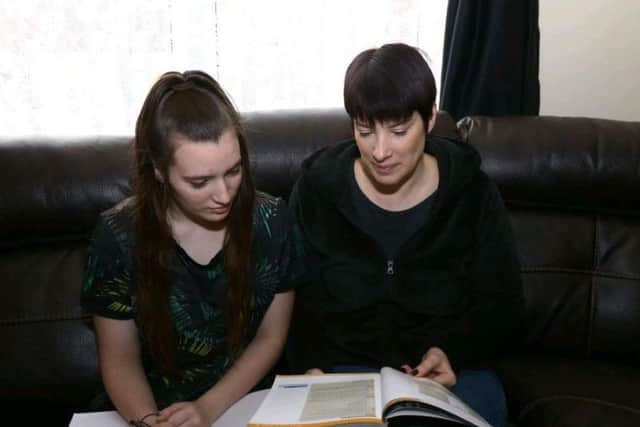 Amber at home with her mum, Joanna. The pair are both appealing for extra tuition help.