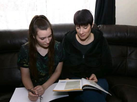 Amber at home with her mum, Joanna. The pair are both appealing for extra tuition help.