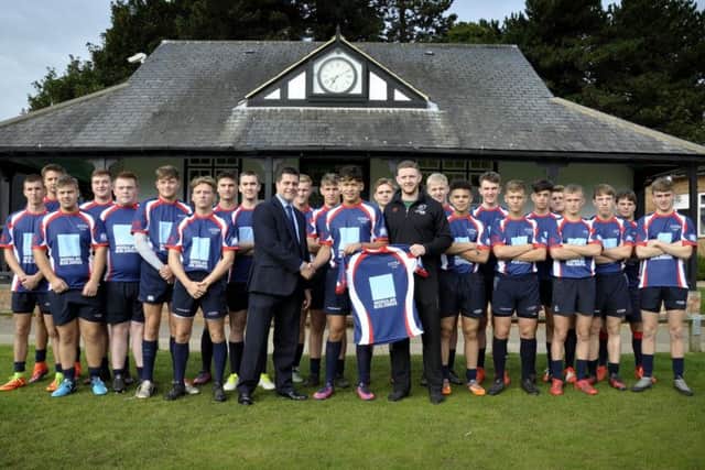 Former NSB player Jack Spittle, now with Nottingham RFC, is pictured handing over the schools new kit to skipper Connor Tupai and headmaster Richard Bernard