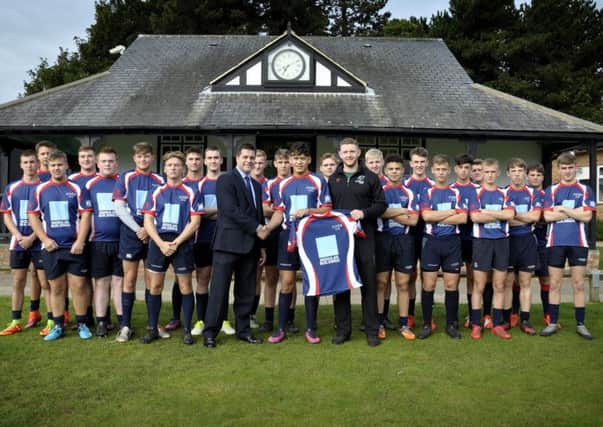 Former NSB player Jack Spittle, now with Nottingham RFC, is pictured handing over the schools new kit to skipper Connor Tupai and headmaster Richard Bernard
