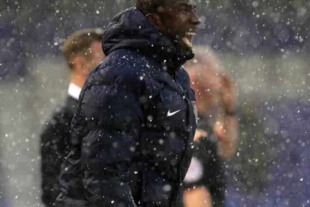 Cobblers boss Jimmy Floyd Hasselbaink watches his team suffer a heavy defeat at a snowy Oldham