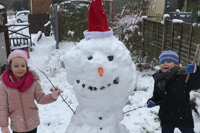Laci and Leo built this snowman, they named him Bob. From Chloe and Tristen in Long Buckby