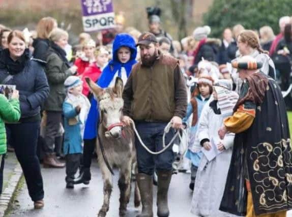 Children and spectators pictured enjoying taking part in a walking nativity. (Library picture).