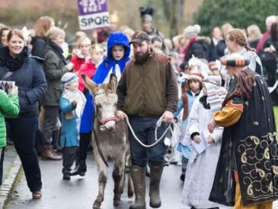Children and spectators pictured enjoying taking part in a walking nativity. (Library picture).
