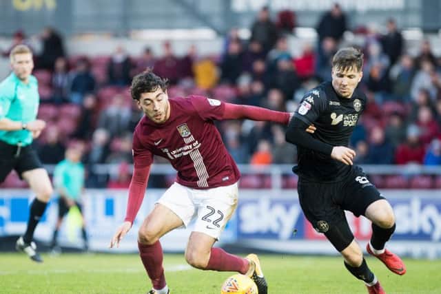 Matt Crooks tangles with Lee Evans during Monday's contest at Sixfields. Pictures: Kirsty Edmonds