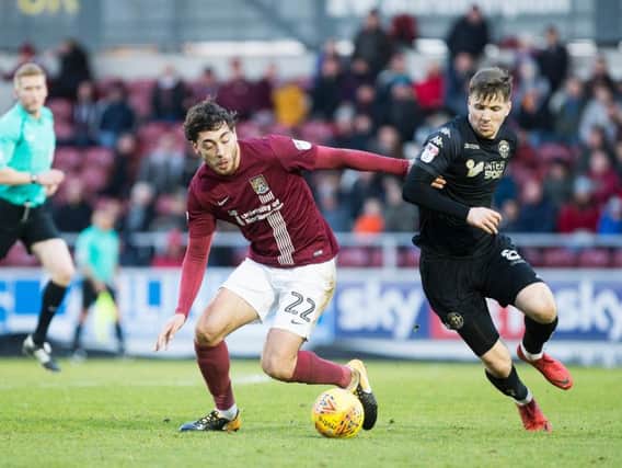 Matt Crooks tangles with Lee Evans during Monday's contest at Sixfields. Pictures: Kirsty Edmonds