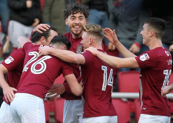 GET IN THERE! - the Cobblers players celebrate John-Joe O'Toole's opening goal in the 3-1 win over Southend United at Sixfields (Pictures: Sharon Lucey)
