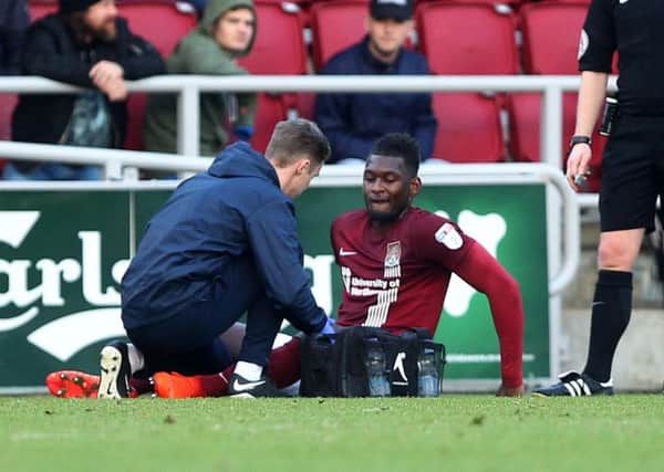 Aaron Pierre is treated by physio Anders Braastad after suffering a thigh injury in the draw with Blackburn Rovers in December