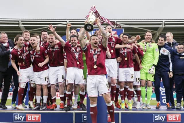 Marc Richards lifts the Sky Bet League Two trophy at Sixfields in April, 2016
