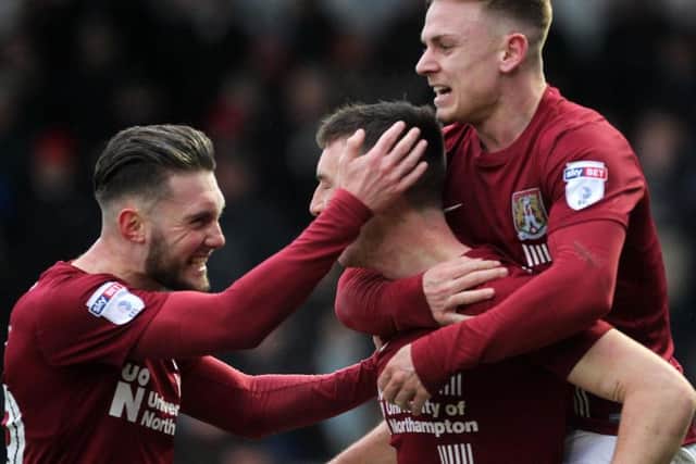 Matt Grimes and Sam Hoskins celebrate Chris Long's winning goal against MK Dons
