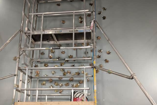 The gold leaf artwork during its installation. NNL-180131-122457005
