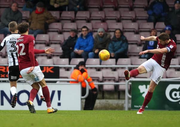 Ash Taylor clears his lines during the Cobblers' 1-0 defeat to Rochdale at Sixfields (Pictures: Sharon Lucey)